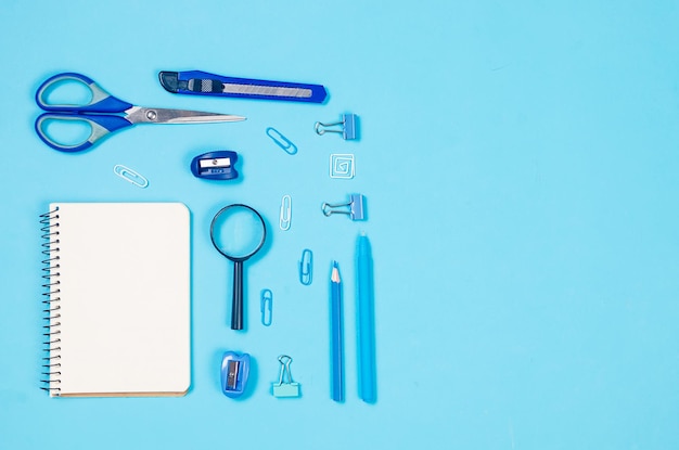 Blue school stationery on blue background