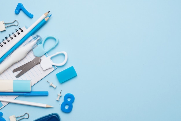 Blue school supplies on blue table