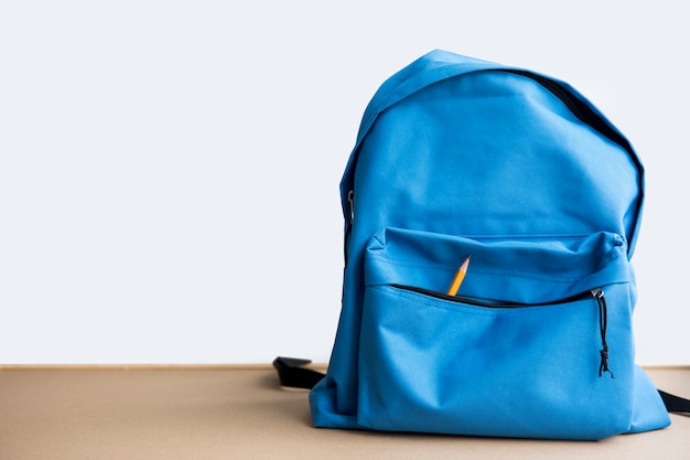 Blue schoolbag with pencil in pocket