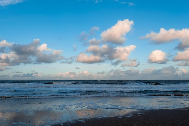 Blue sea or ocean in the morning with white clouds on the blue sky calm scenery on the beach