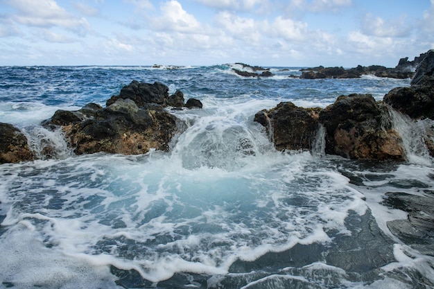 Blue sea and rocks storming wave spray over rocks rocky sea coast