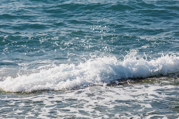 Blue sea texture with waves and foam