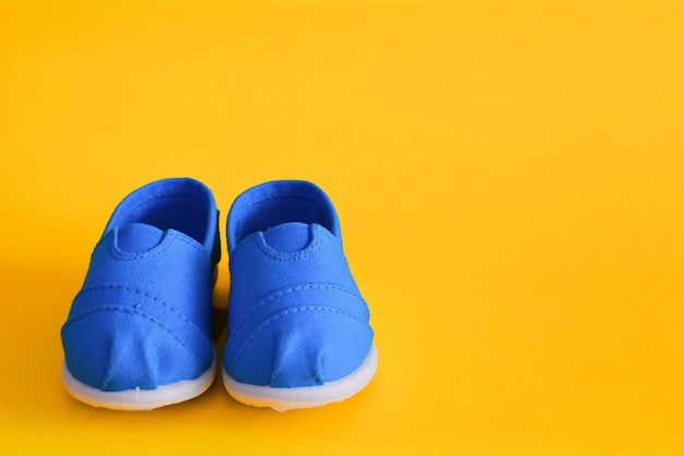 Blue shoes for children on yellow