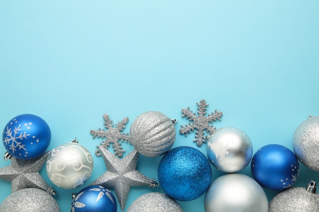 Blue and silver christmas bauble balls on blue background.