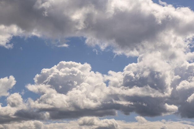 Blue sky background with big white tiny stratus cirrus striped clouds