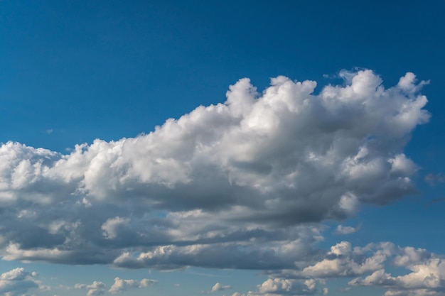 Blue sky background with big white tiny stratus cirrus striped clouds