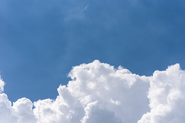 Blue sky background with a fluffy clouds