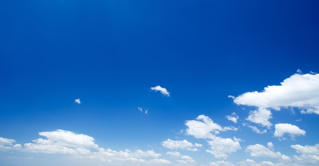 Blue sky background with a tiny clouds