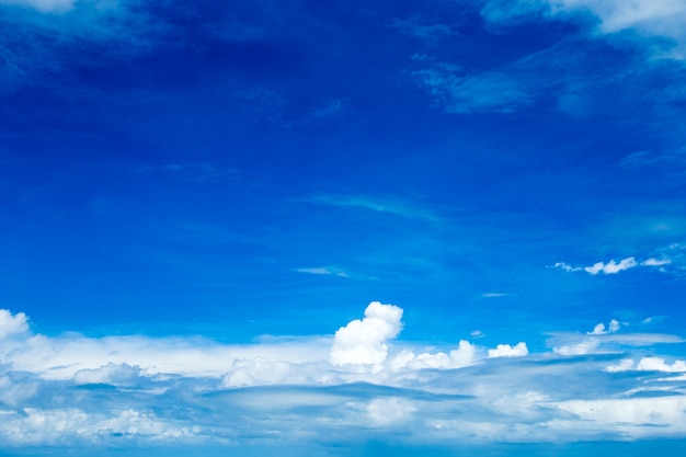 Blue sky background with tiny clouds