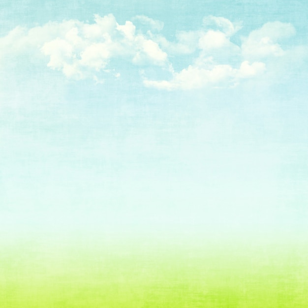 Blue sky, clouds and green field summer grunge abstract background