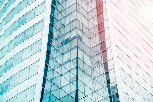 Blue sky reflected in the glass building. Abstract architecture pattern background.