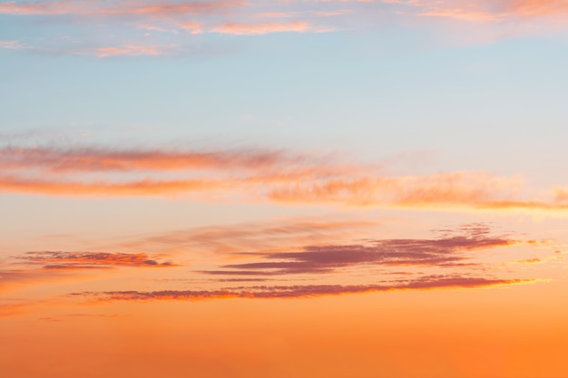 Blue sky at sunset with bright stains of orange and pink