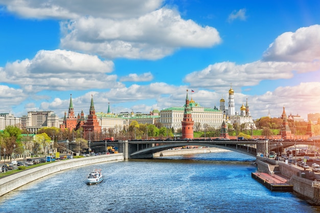 Blue sky and white clouds over the Moscow Kremlin and a pleasure boat