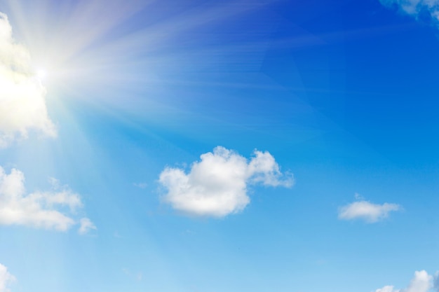 Blue sky with clouds and bright sunlight. High quality photo