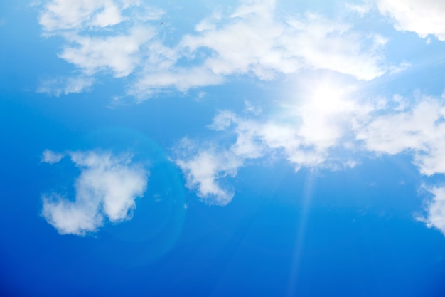 Blue sky with clouds and bright sunlight. High quality photo