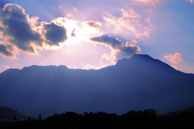 Blue sky with clouds and mountains peak