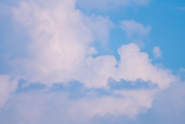 A blue sky with clouds and a plane in the sky