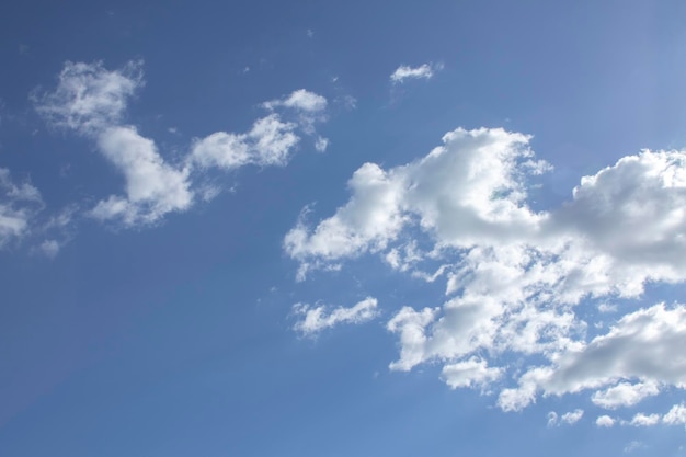 A blue sky with white clouds as a background