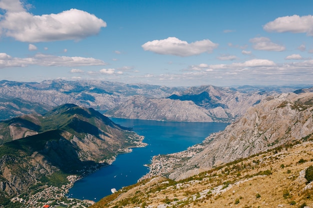 Blue sky with white clouds over the azure water of the bay of kotor mount lovcen