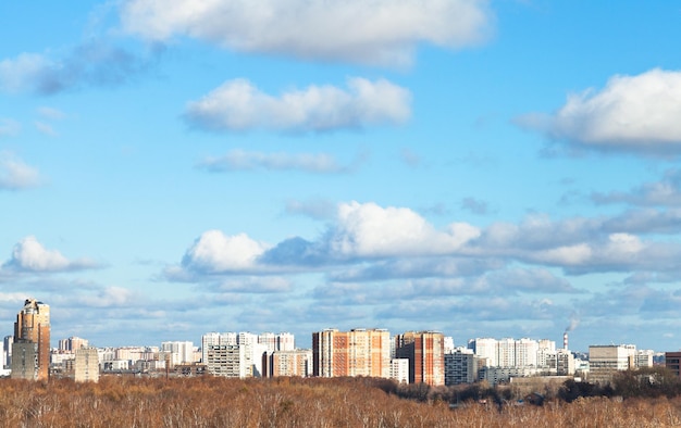 Blue sky with white clouds over city in autumn day