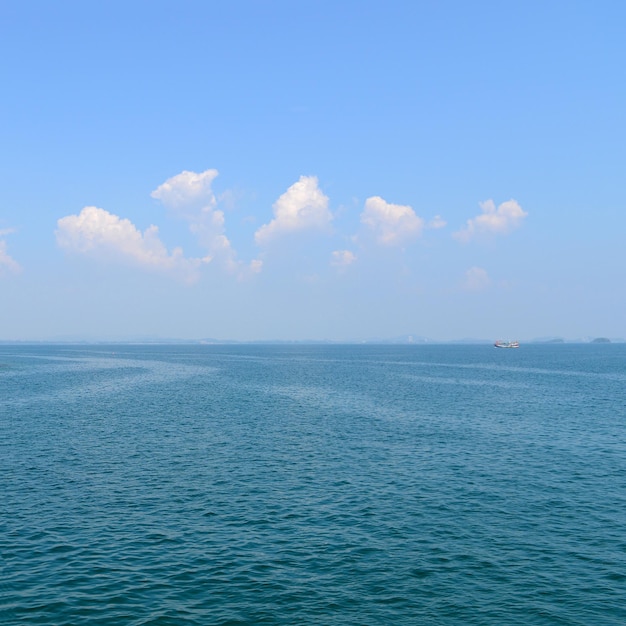 Blue sky with white clouds and sea