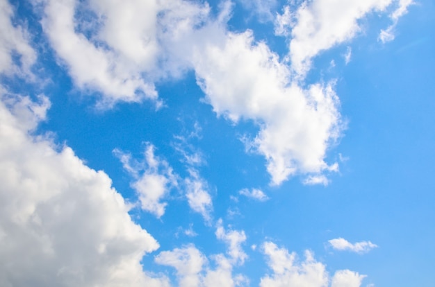 Blue sky with white summer cumulus clouds.