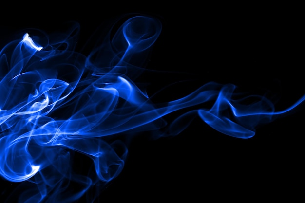 Blue smoke abstract on black background for design darkness concept