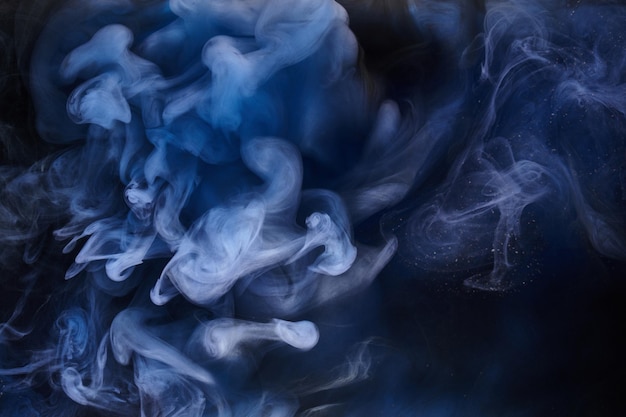 Blue smoke on black ink background, colorful fog, abstract swirling ocean sea, acrylic paint pigment underwater