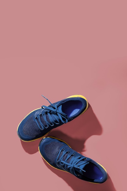 Blue sneakers on a  pink background