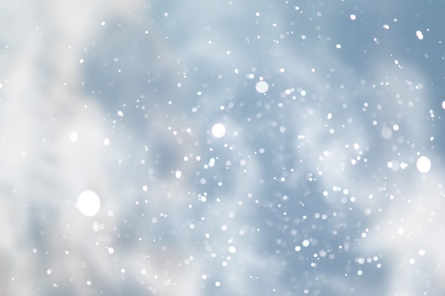 Blue snowfall bokeh background, abstract snowflake background blurred abstract blue