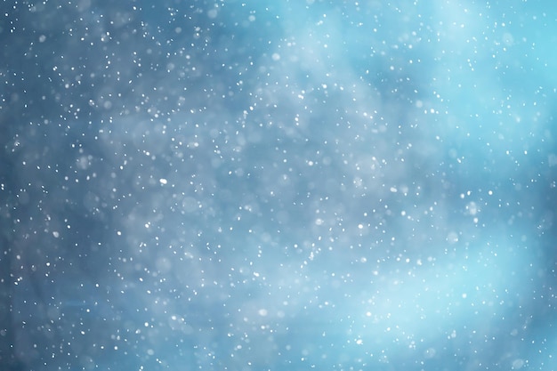 blue snowfall bokeh background, abstract snowflake background on blurred abstract blue