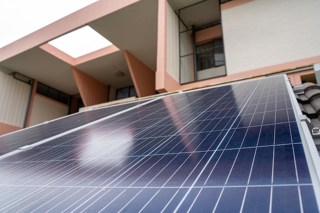 Blue Solar Photo voltaic panels system of apartment building on sunny day Renewable ecological green energy