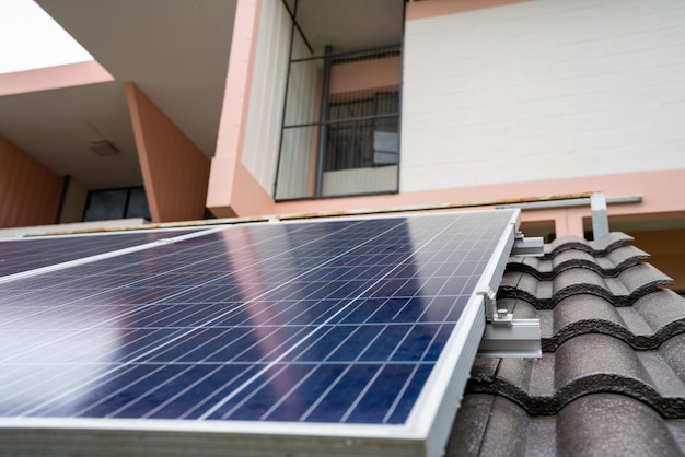 Blue Solar Photo voltaic panels system of apartment building on sunny day Renewable ecological green energy