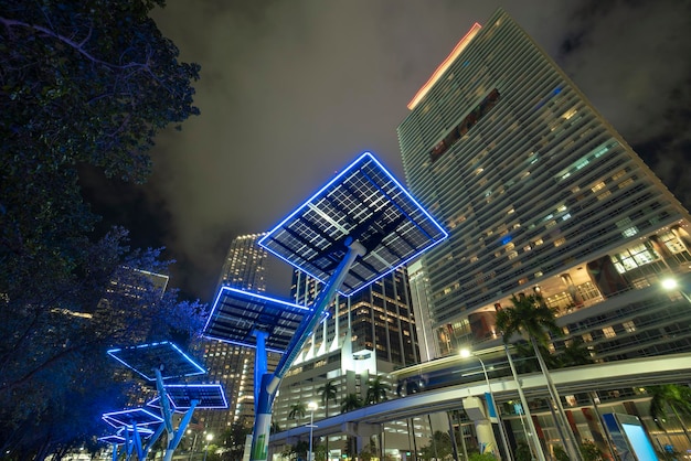 Blue solar photovoltaic panels mounted in modern city on street poles for electricity supply of streetlights and surveillance cameras Futuristic energy source in downtown Miami Florida