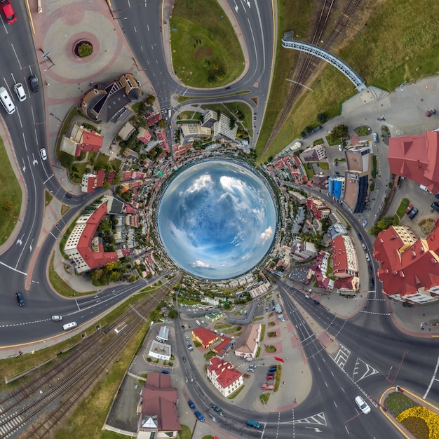 Blue sphere inside overlooking old town urban development historic buildings and crossroads with cars Transformation of spherical 360 panorama in abstract aerial view