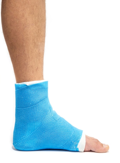 Blue splint ankle. Bandaged leg cast on male patient isolated. Sports injury concept.