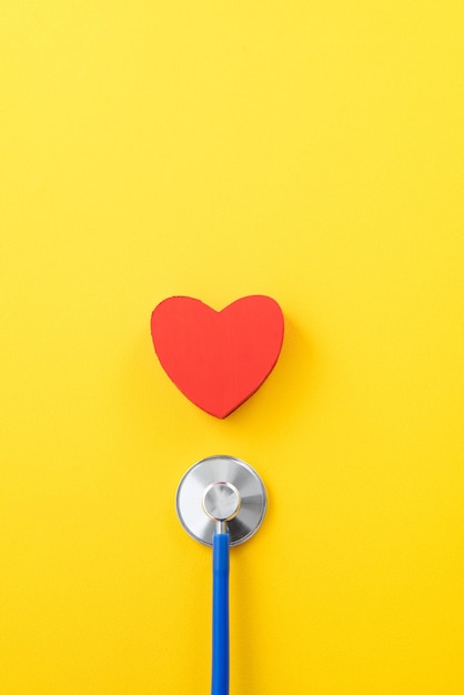 Blue stethoscope with red heart medical care design concept