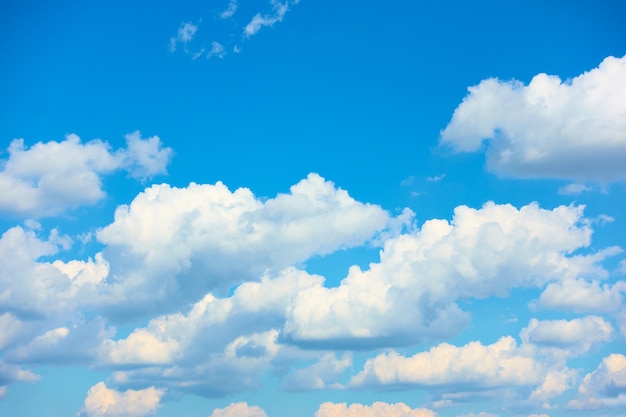 Blue summer sky with white heap clouds - background with space for your own text. Cloudscape