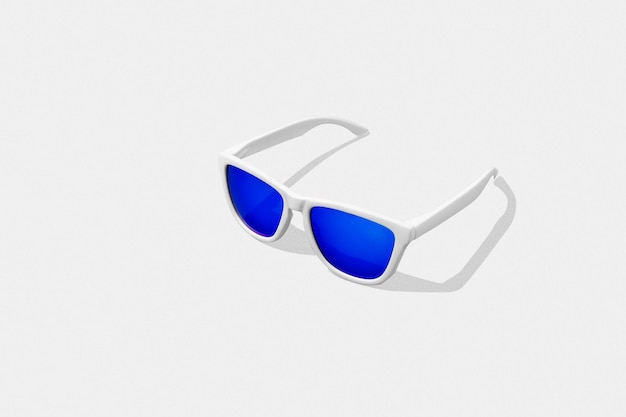 Blue sunglasses isolated on white background. Studio shot of sunglasses for mockup.