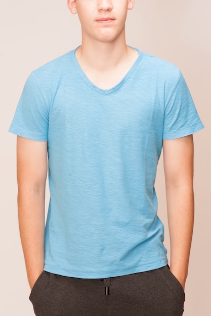 Blue t-shirt on a young man isolated, front