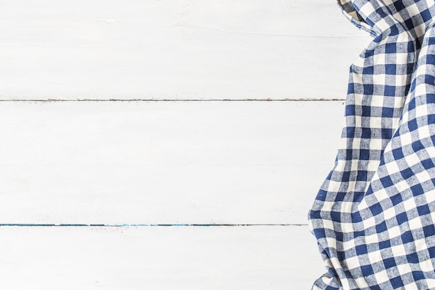 Blue table cloth on white background, copy space, top view.