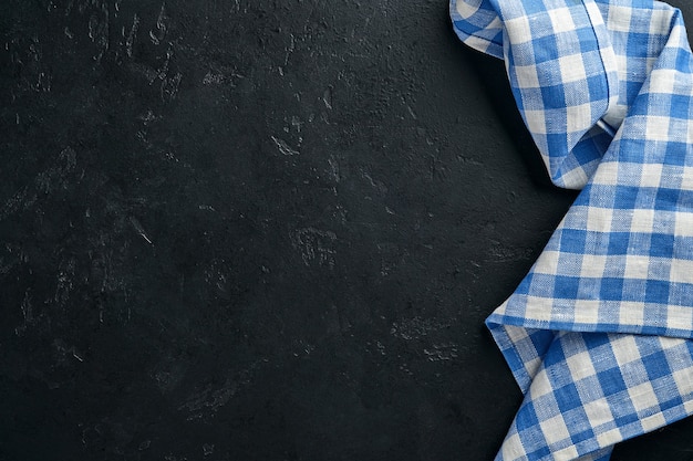 Blue tablecloth on kitchen table black color with for your recipe or menu.