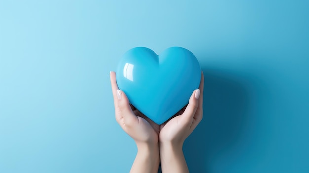 Blue textured cute heart in hands on a clean blue background Kindness is in the hands of man Valentine's day concept banner