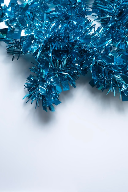 Photo blue tinsel on a white background with copy space for text