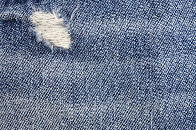 Blue torn denim jeans texture.