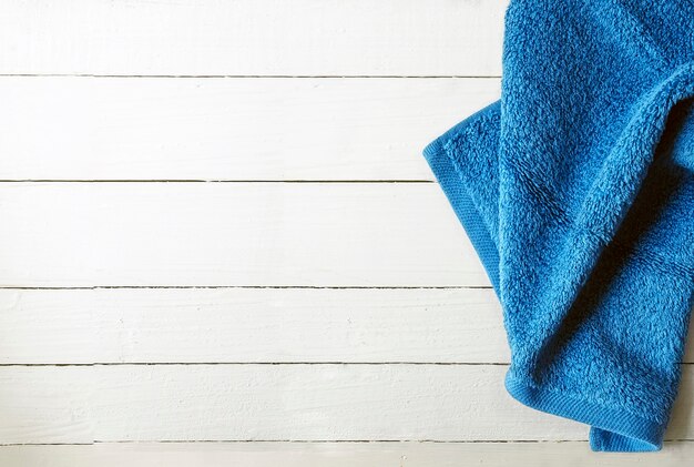 Blue towel on  white wooden background