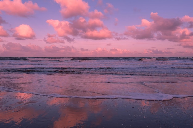 Blue violet and purple sea or ocean in the morning with white clouds on the blue sky calm scenery