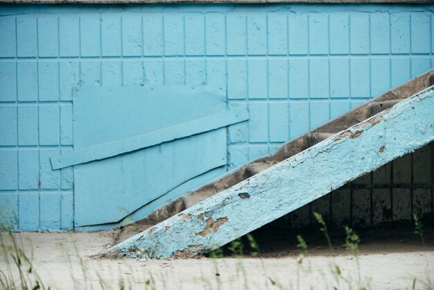 Blue wall of building with hatch and stairway