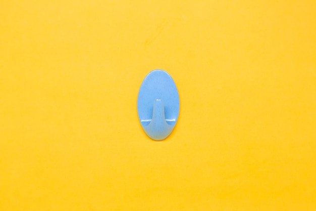 A Blue Wall Hanger in The Yellow Background