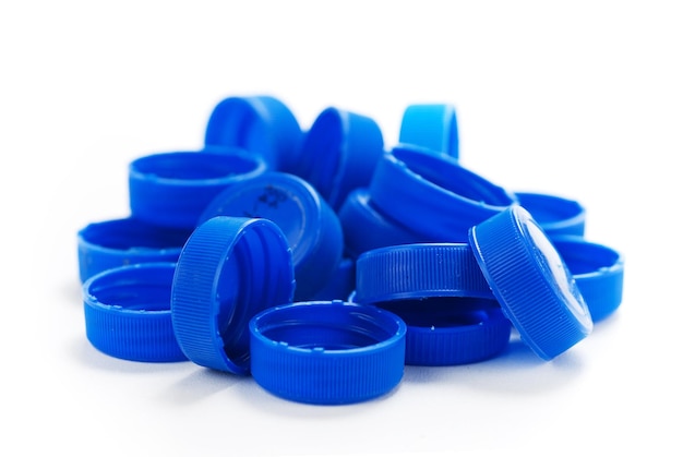 Blue water bottle plastic caps over a white background